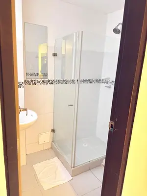 a bathroom with a shower and a sink at Hotel California Blue Manizales in Manizales