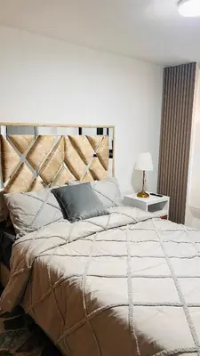a bedroom with a large bed with a wooden headboard at Hermoso apartamento nuevo ! A un paso de la 70 zona vip in Medellín
