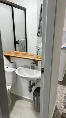 a bathroom with a white sink and a toilet at Hermoso apartamento nuevo ! A un paso de la 70 zona vip in Medellín