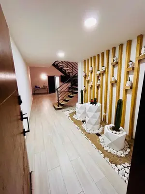 a hallway with a staircase in a house with a cactus at FIincaVilla Cavil a 50 min de Medellin in Sopetran