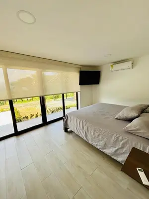 a bedroom with a bed and a large window at FIincaVilla Cavil a 50 min de Medellin in Sopetran