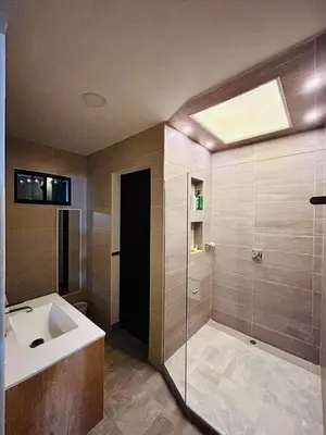 a bathroom with a sink and a glass shower at FIincaVilla Cavil a 50 min de Medellin in Sopetran
