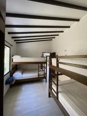 a room with several bunk beds in it at FIincaVilla Cavil a 50 min de Medellin in Sopetran