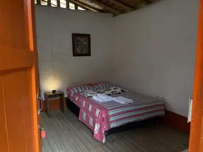 a small room with a small bed in it at Aldea Los Pioneros in Venecia