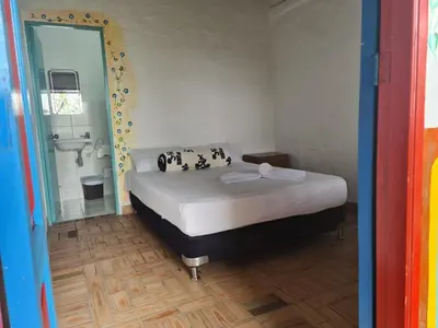 a bedroom with a bed and a bathroom with a sink at Aldea Los Pioneros in Venecia