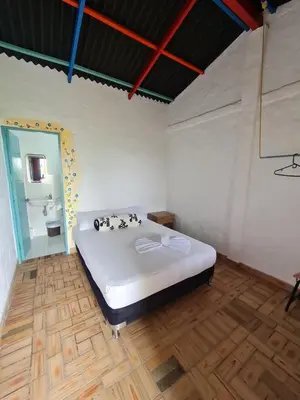 a bedroom with a large white bed in a room at Aldea Los Pioneros in Venecia