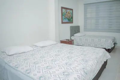a bedroom with two beds and a window at Hostel North SAS in Medellín