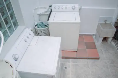 a kitchen with a white stove and a dishwasher at Hostel North SAS in Medellín