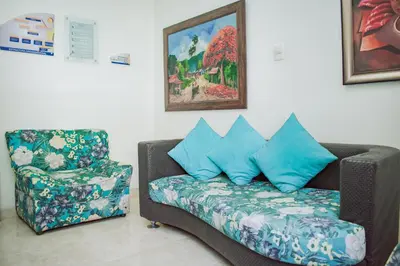 a living room with a couch and a chair at Hostel North SAS in Medellín