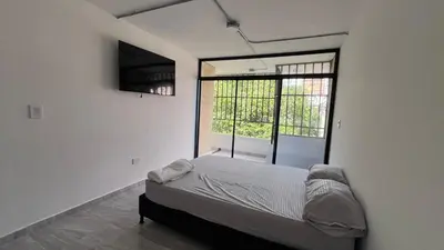 a bedroom with a bed and a window at Acogedor Loft Medellin cerca al Estadio Atanasio in Medellín