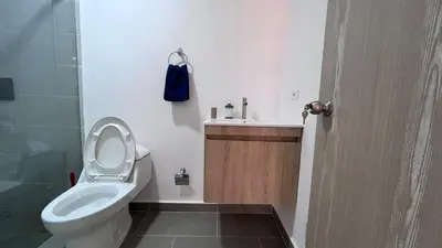 a bathroom with a toilet and a sink at Acogedor Loft Medellin cerca al Estadio Atanasio in Medellín