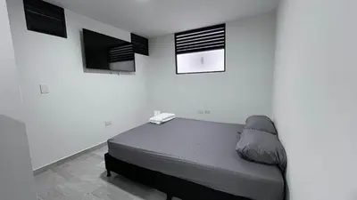 a bedroom with a bed and three pictures on the wall at Alojamiento entero loft en Medellin, Estadio in Medellín