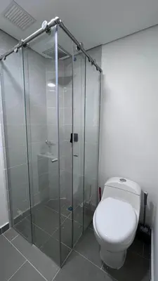 a bathroom with a toilet and a glass shower at Alojamiento entero loft en Medellin, Estadio in Medellín