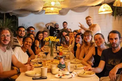 a group of people sitting at a table eating at Co404 Medellin - Coliving Coworking in Medellín