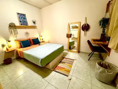 a bedroom with a bed and a desk and a mirror at Co404 Medellin - Coliving Coworking in Medellín