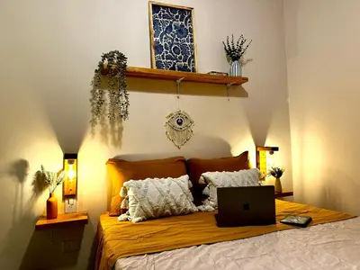 a bedroom with a bed with a laptop on it at Co404 Medellin - Coliving Coworking in Medellín
