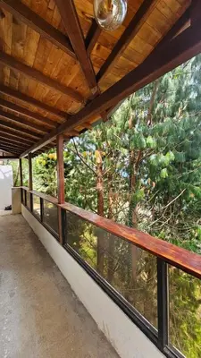 a room with a balcony with a view of a forest at Aitana Mágica in Copacabana