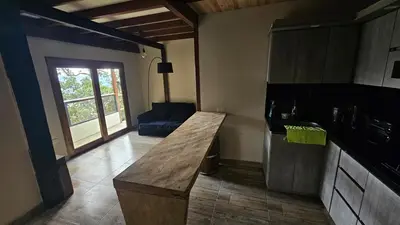 a kitchen with a counter and a couch in a room at Aitana Mágica in Copacabana