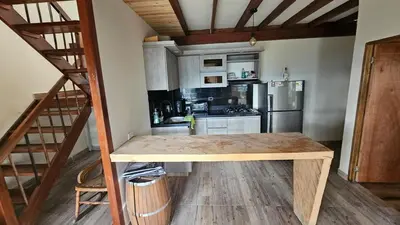 a kitchen with a wooden table in a room at Aitana Mágica in Copacabana