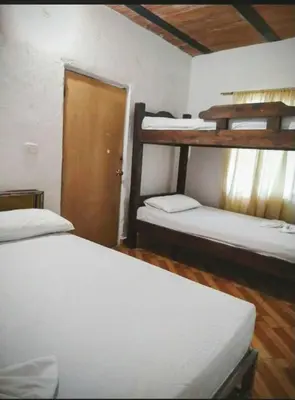 a bedroom with two bunk beds and a door at Finca Mi Delirio in Cocorná