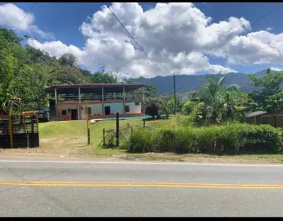 a house on the side of a street with a road at Finca Mi Delirio in Cocorná