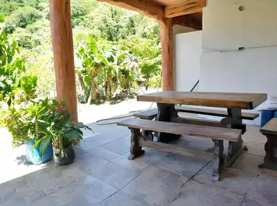 a picnic table and a bench on a patio at Finca Mi Delirio in Cocorná