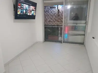 a room with a white tiled floor and a window at WalApar in San Rafael