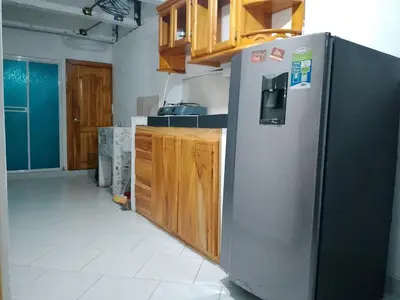 a kitchen with a stainless steel refrigerator and wooden cabinets at WalApar in San Rafael