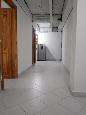 an empty hallway with a refrigerator in a room at WalApar in San Rafael