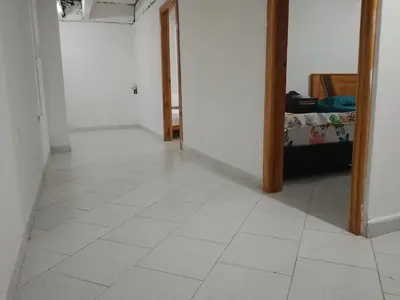 a hallway with a white tiled floor in a room at WalApar in San Rafael