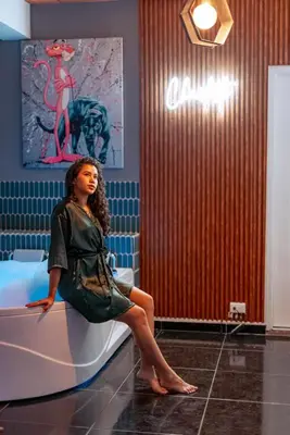 a woman sitting on a toilet in a room at Charlotte Alojamiento in Medellín