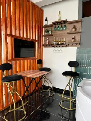 a kitchen with a table and stools in a room at Charlotte Alojamiento in Medellín