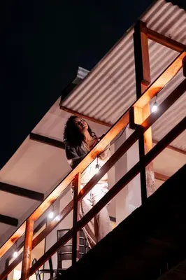 a person standing on top of a building with lights at Charlotte Alojamiento in Medellín