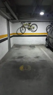 a bike hanging from a wall in a parking garage at exclusive pink zone sabaneta friends and fun in Sabaneta