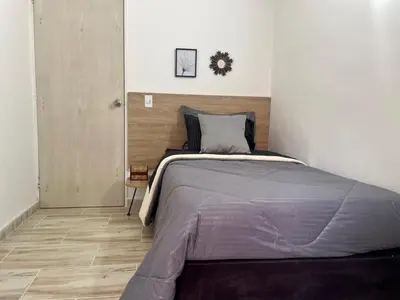 a bedroom with a large bed in a room at exclusive pink zone sabaneta friends and fun in Sabaneta