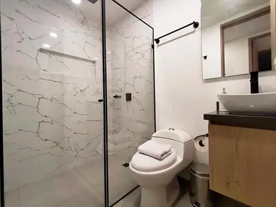 a bathroom with a toilet and a sink at Edificio OA Aparta-suites in Medellín
