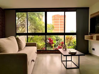 a living room with a couch and a table at Edificio OA Aparta-suites in Medellín