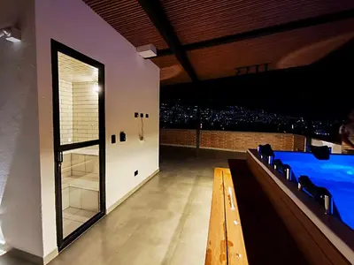 a room with a table and a view of a city at Edificio OA Aparta-suites in Medellín
