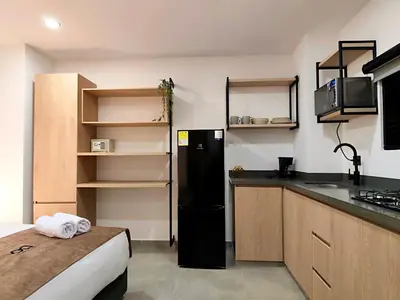 a kitchen with a black refrigerator in a room at Edificio OA Aparta-suites in Medellín