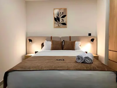 a bedroom with a large bed with towels on it at Edificio OA Aparta-suites in Medellín