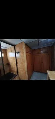 an overhead view of a kitchen with wooden cabinets at Hostel La Casona in Medellín