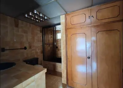 a kitchen with wooden cabinets and a sink at Hostel La Casona in Medellín