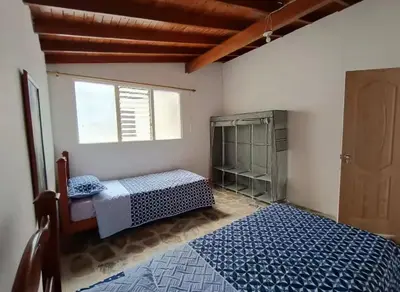 a bedroom with a bed and a window at Hostel La Casona in Medellín