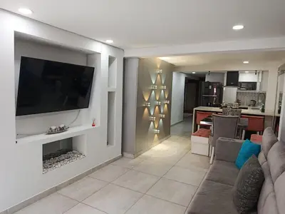 a living room with a flat screen tv on a wall at Refugio Sereno en Itagüí in Itagüí