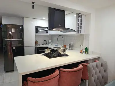 a kitchen with a counter with a sink and a stove at Refugio Sereno en Itagüí in Itagüí