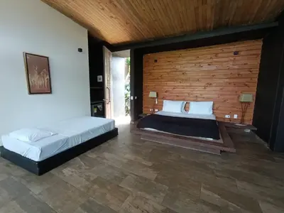 a bedroom with two beds and a wooden wall at Madeira Majestic Hotel in Doradal