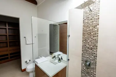 a bathroom with a sink and a toilet and a mirror at Finca la Princesa Eastern Antioquia in Carmen de Viboral