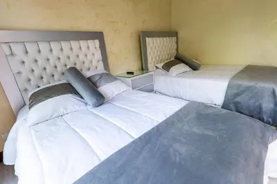 two beds sitting next to each other in a room at Finca la Princesa Eastern Antioquia in Carmen de Viboral