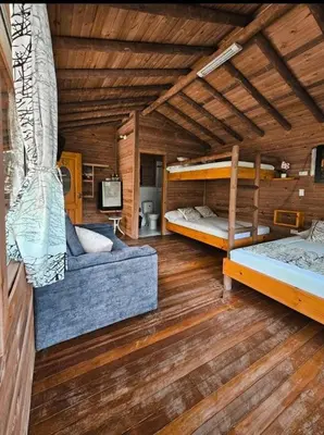 a room with two bunk beds and a couch at La Chorrera ecohotel in Cocorná