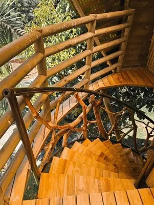a wooden stairway with a wooden railing on it at La Chorrera ecohotel in Cocorná